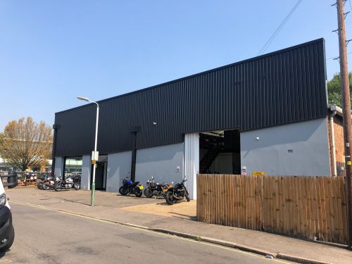 Click Here To Enlarge This Photo Of REFURBISHMENT Overclad existing Masonry Walls with 0.7mm Thick Pre Coated Black Prisma, Ral 9005 Galvanised Steel Profile Vertical Cladding